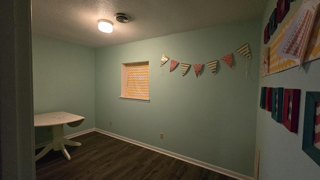 office area featuring dark hardwood / wood-style floors and a textured ceiling