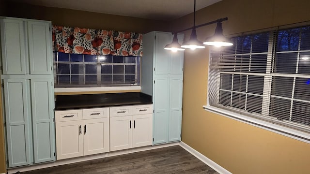 kitchen with pendant lighting, white cabinets, and dark hardwood / wood-style flooring