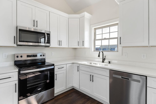 kitchen featuring white cabinets, appliances with stainless steel finishes, sink, and dark hardwood / wood-style flooring