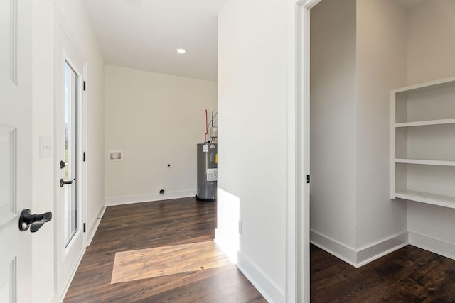 hallway with water heater and dark hardwood / wood-style flooring