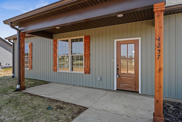 view of exterior entry featuring a patio area