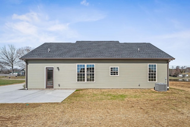 back of house featuring central air condition unit, a patio, and a yard