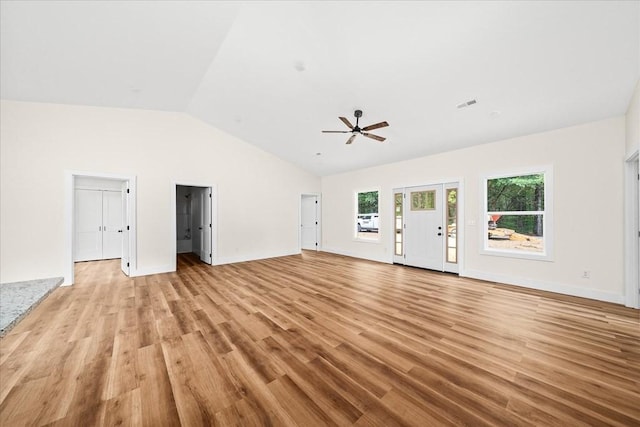 unfurnished living room featuring ceiling fan, vaulted ceiling, and light wood-type flooring