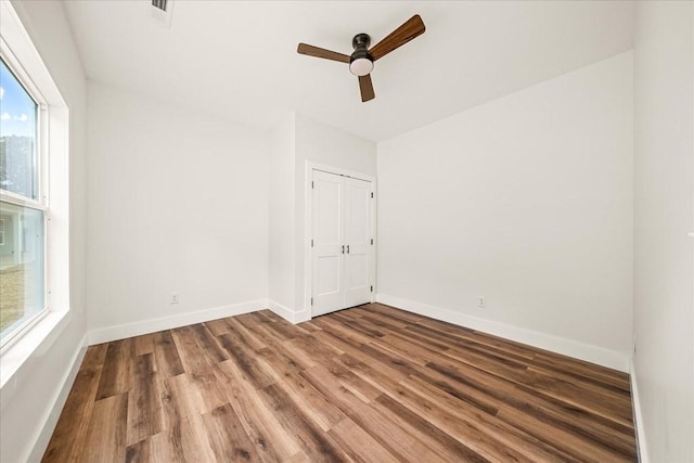 unfurnished room featuring hardwood / wood-style floors and ceiling fan