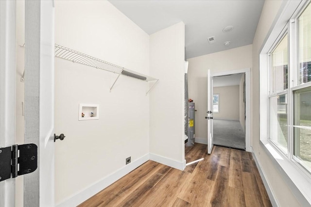 washroom with hookup for a washing machine, water heater, and hardwood / wood-style flooring