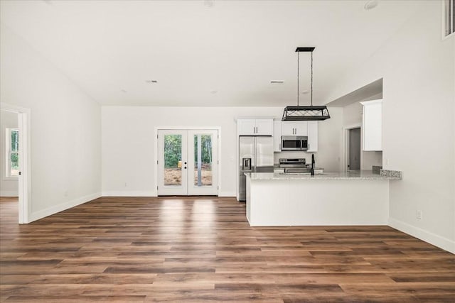 kitchen featuring pendant lighting, white cabinetry, stainless steel appliances, kitchen peninsula, and french doors