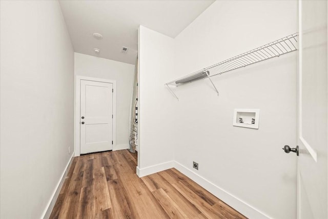 laundry area featuring washer hookup, hardwood / wood-style flooring, and hookup for an electric dryer