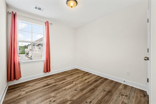 spare room with wood-type flooring