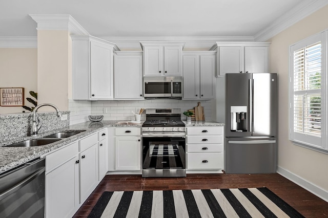 kitchen featuring sink, stainless steel appliances, light stone counters, ornamental molding, and white cabinets