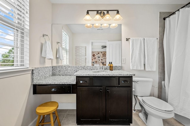 bathroom with tile patterned flooring, vanity, curtained shower, and toilet