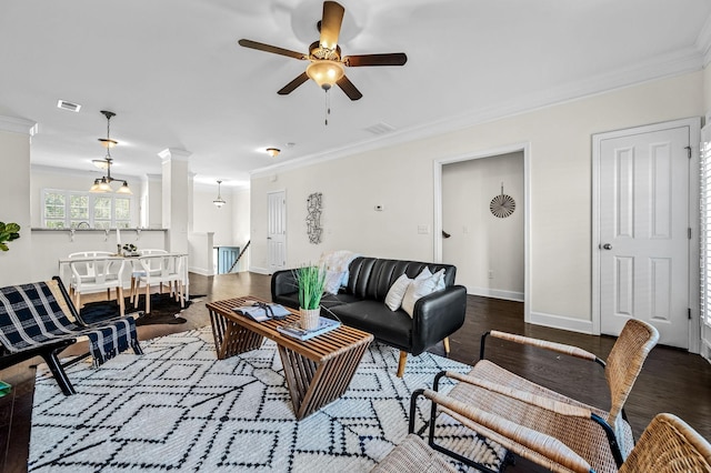 living room featuring crown molding, decorative columns, and ceiling fan