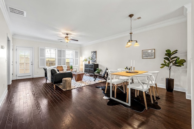 dining area featuring dark hardwood / wood-style flooring, ornamental molding, and ceiling fan