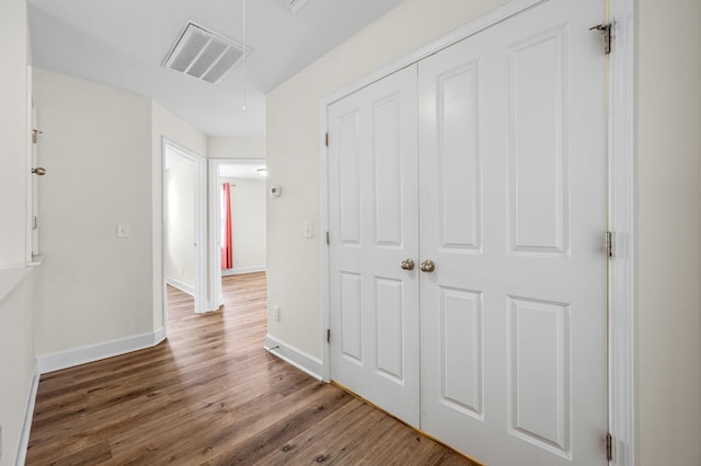 corridor featuring dark wood-type flooring