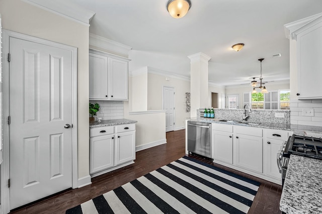 kitchen featuring sink, light stone counters, white cabinets, stainless steel appliances, and backsplash