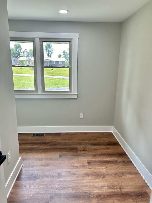 unfurnished room with hardwood / wood-style flooring and a wealth of natural light