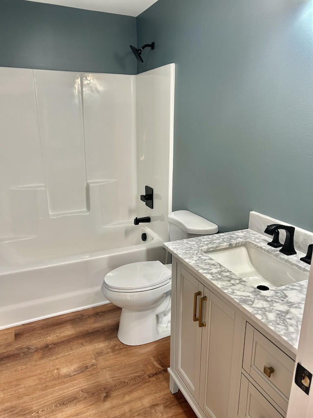 full bathroom featuring vanity, shower / bathing tub combination, wood-type flooring, and toilet