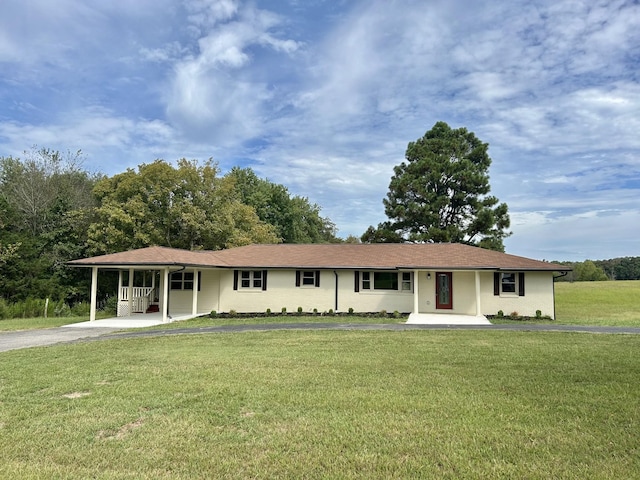 ranch-style home featuring a front yard and a carport