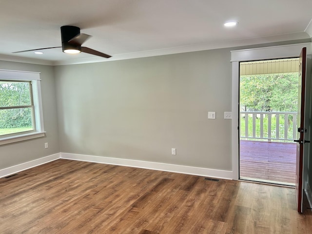 empty room with ceiling fan, ornamental molding, and wood-type flooring