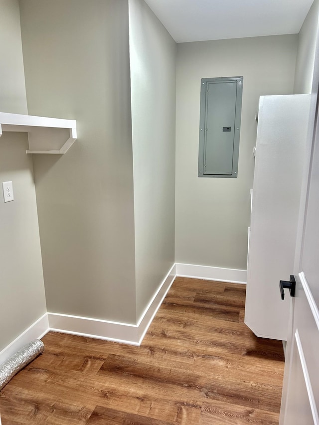 hallway featuring wood-type flooring and electric panel