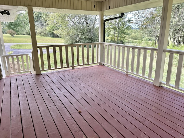 wooden terrace with a yard