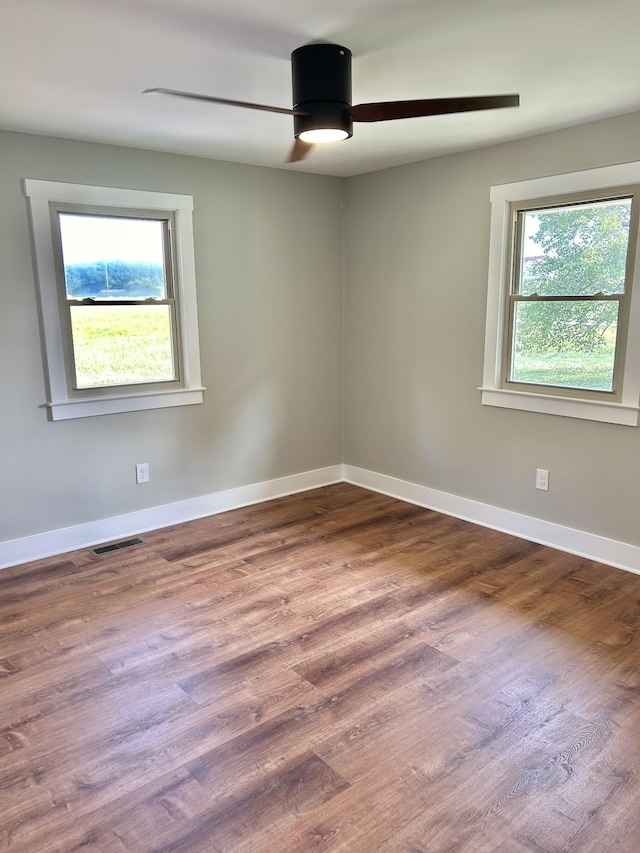 unfurnished room featuring hardwood / wood-style flooring and ceiling fan