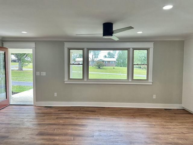 unfurnished room featuring wood-type flooring, ornamental molding, and ceiling fan