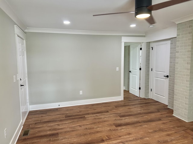 spare room featuring ornamental molding, dark hardwood / wood-style floors, and ceiling fan