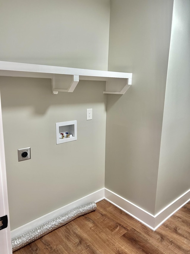 clothes washing area with hardwood / wood-style flooring, washer hookup, and hookup for an electric dryer