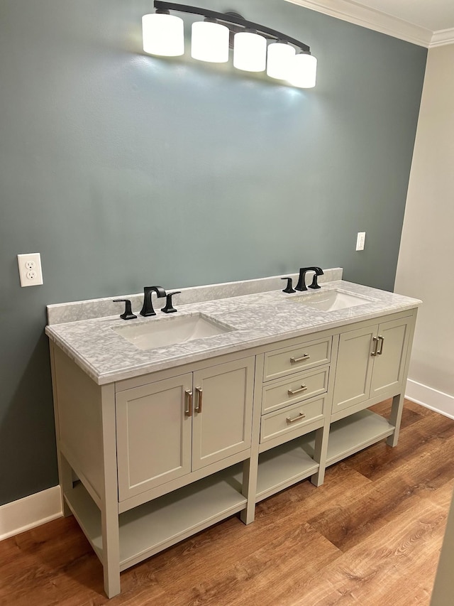 bathroom featuring vanity, hardwood / wood-style floors, and ornamental molding