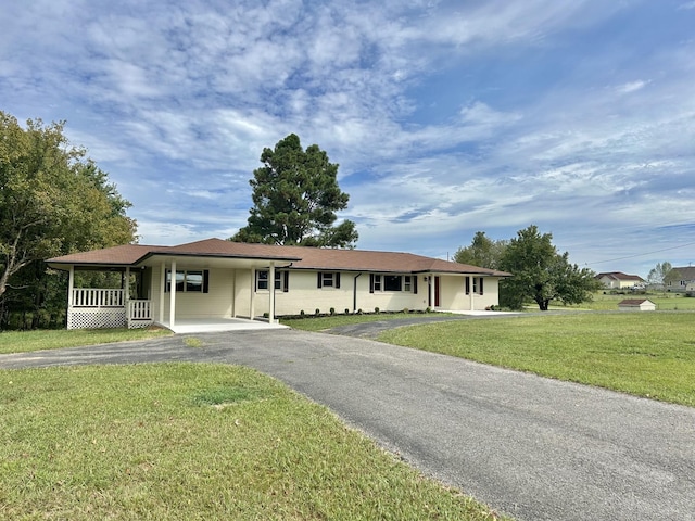 single story home featuring a front lawn and a carport