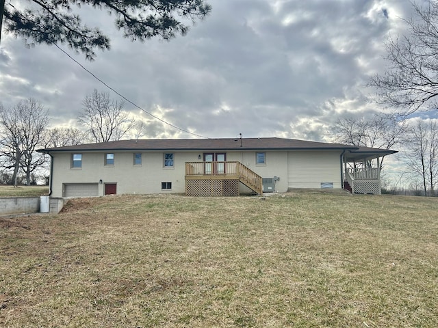 back of house with a garage, a wooden deck, central AC, and a lawn