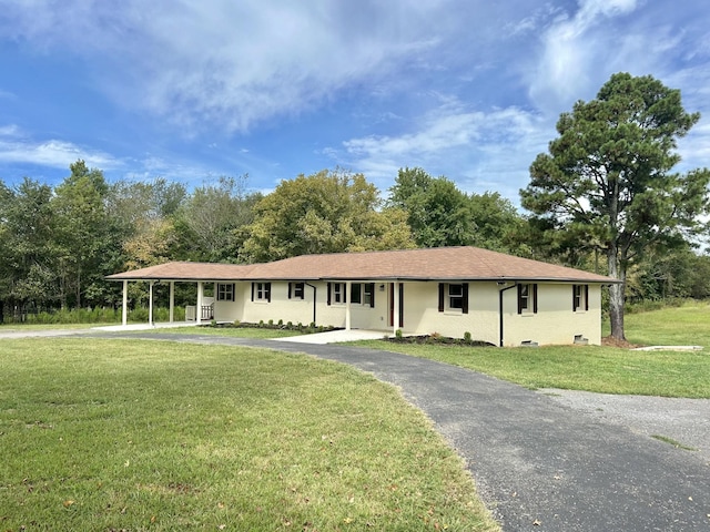 ranch-style home with a carport and a front lawn