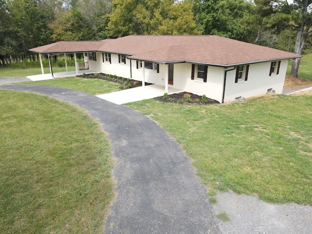 ranch-style house featuring a carport and a front yard