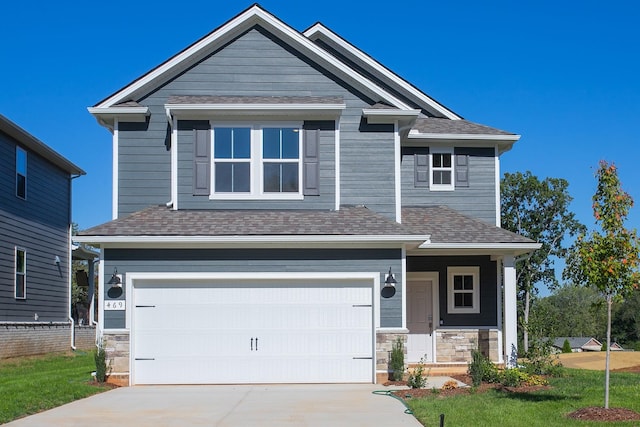 craftsman inspired home with a garage and a front lawn