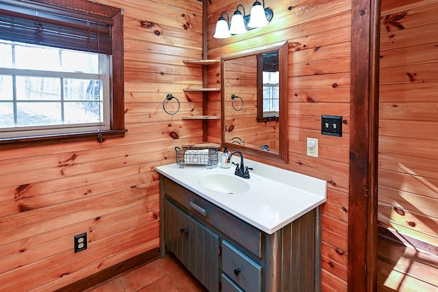 bathroom featuring vanity, tile patterned flooring, and wood walls