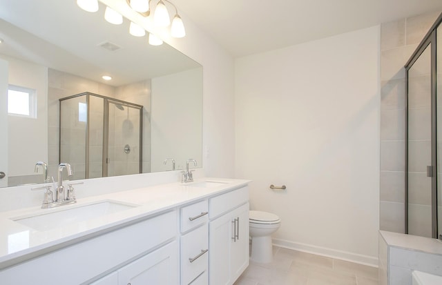 bathroom with vanity, tile patterned flooring, a shower with shower door, and toilet