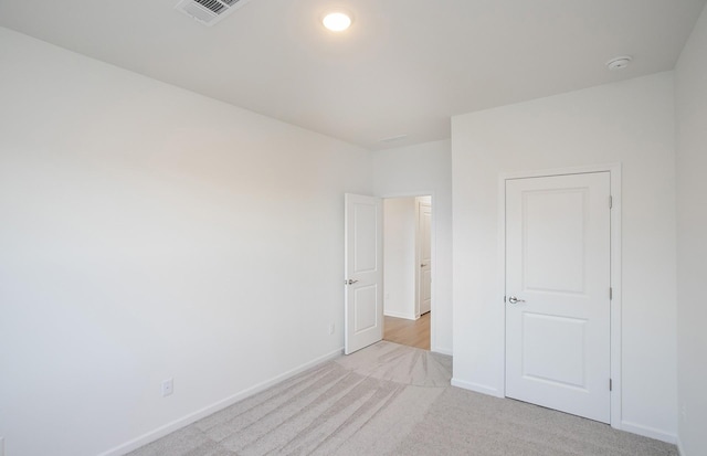 unfurnished bedroom featuring light colored carpet