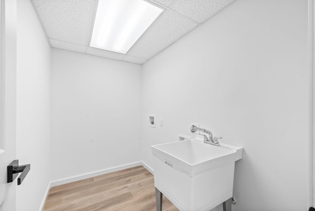 laundry area with hardwood / wood-style flooring, sink, and hookup for a washing machine