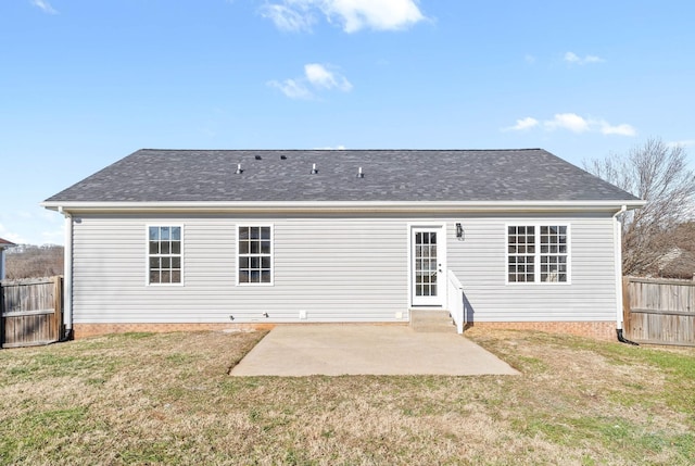 back of house featuring a patio and a lawn