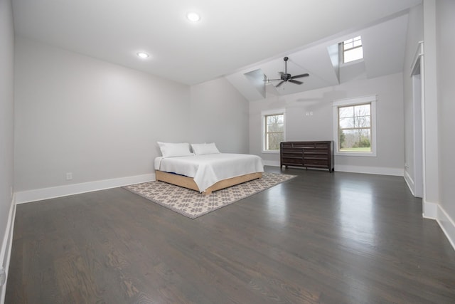 unfurnished bedroom with vaulted ceiling, dark hardwood / wood-style floors, and ceiling fan