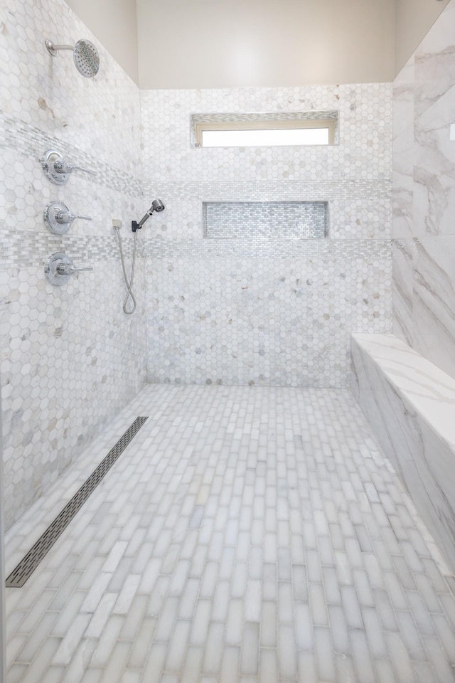 bathroom with tiled shower