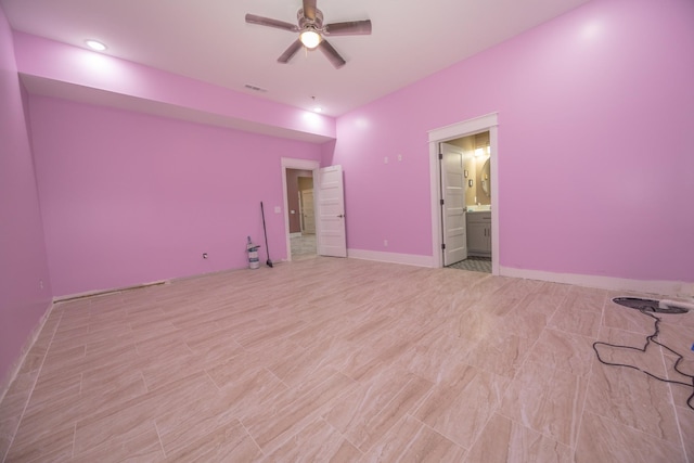 unfurnished bedroom featuring ensuite bathroom and ceiling fan