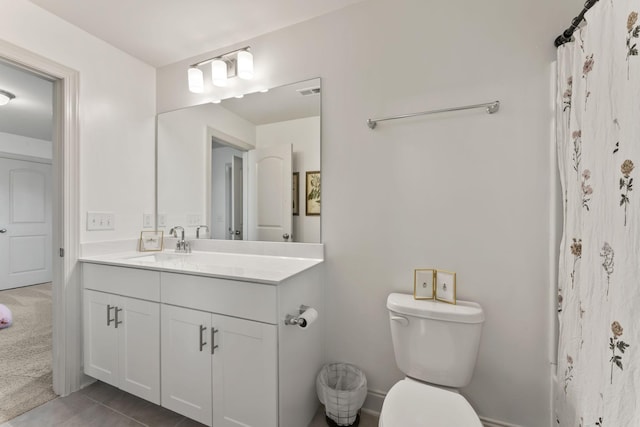 bathroom featuring vanity, tile patterned floors, toilet, and walk in shower