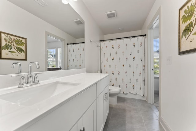 bathroom with vanity, tile patterned flooring, and toilet