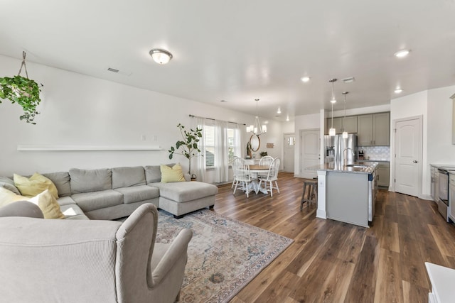 living room with sink and dark hardwood / wood-style floors