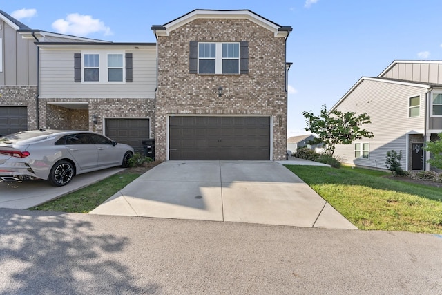 view of front of property featuring a garage and a front lawn