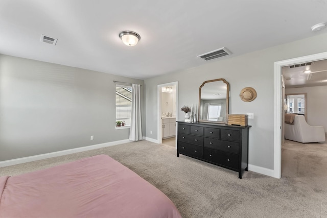 carpeted bedroom with connected bathroom