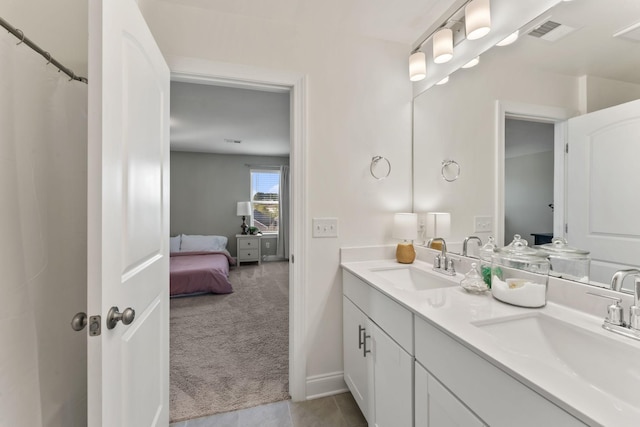 bathroom with tile patterned flooring and vanity