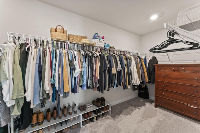 spacious closet featuring light colored carpet