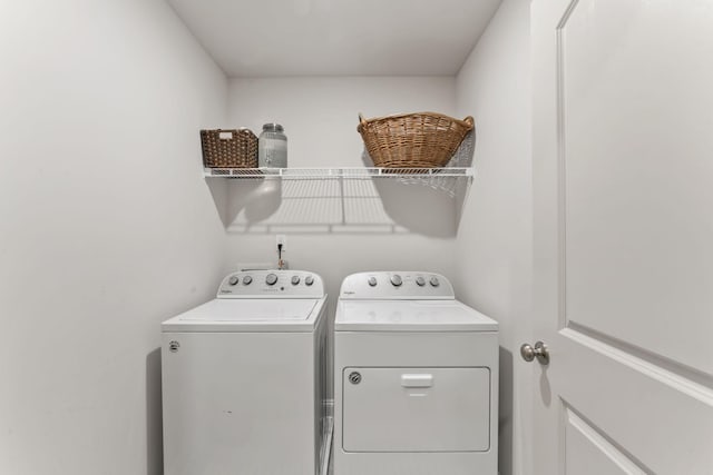 laundry area with washing machine and clothes dryer